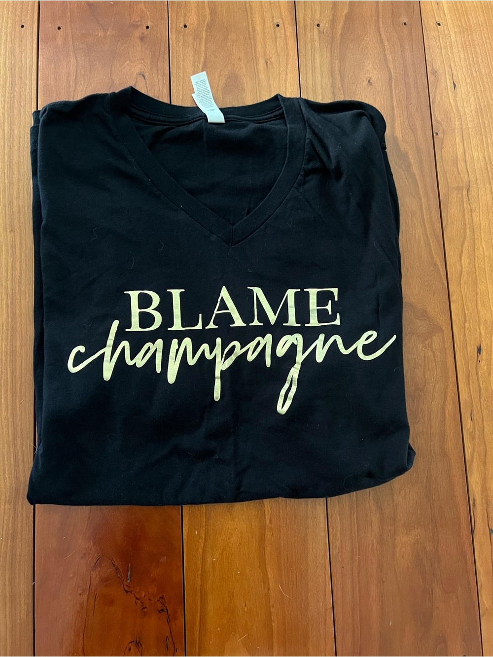 Black V-Neck Tee with "Blame Champagne" Script—like new!